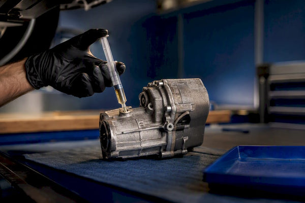 Technician filling Haldex coupling with oil